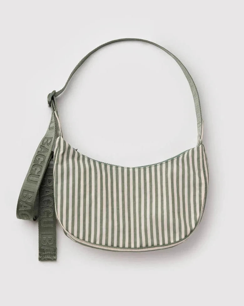 Green and white striped handbag with a strap on a light gray background