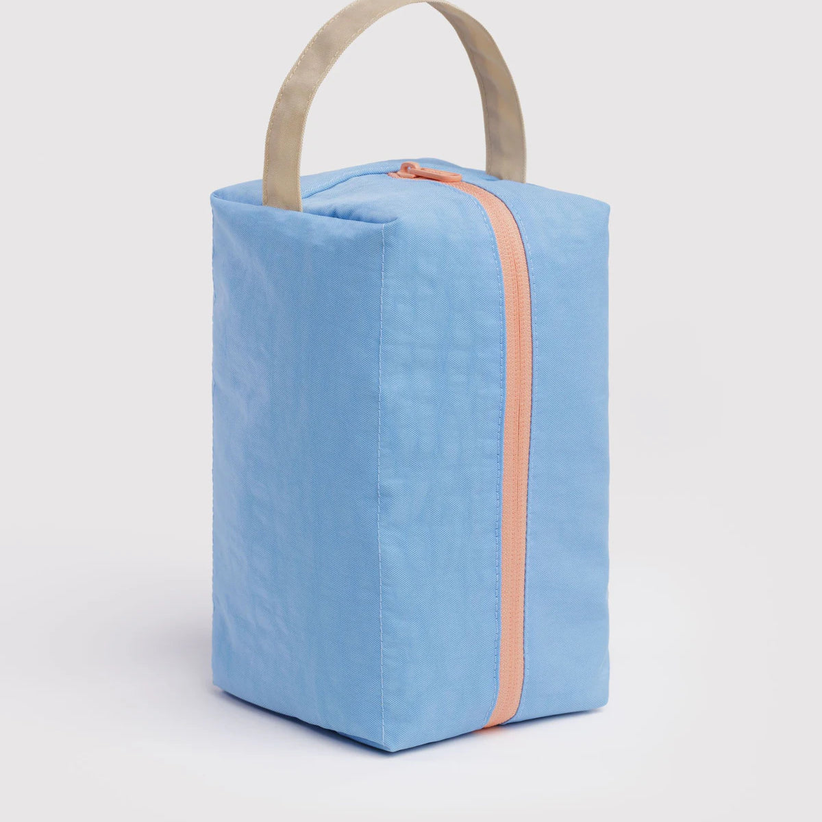 Blue rectangular bag with a handle on a light gray background