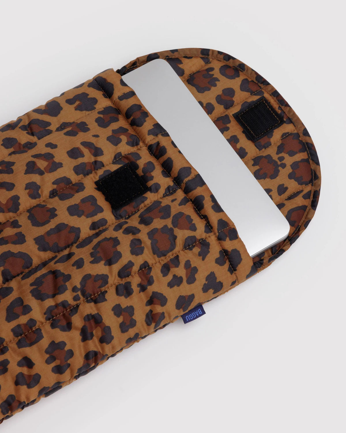 Leopard print bag with a metal handle on a white background