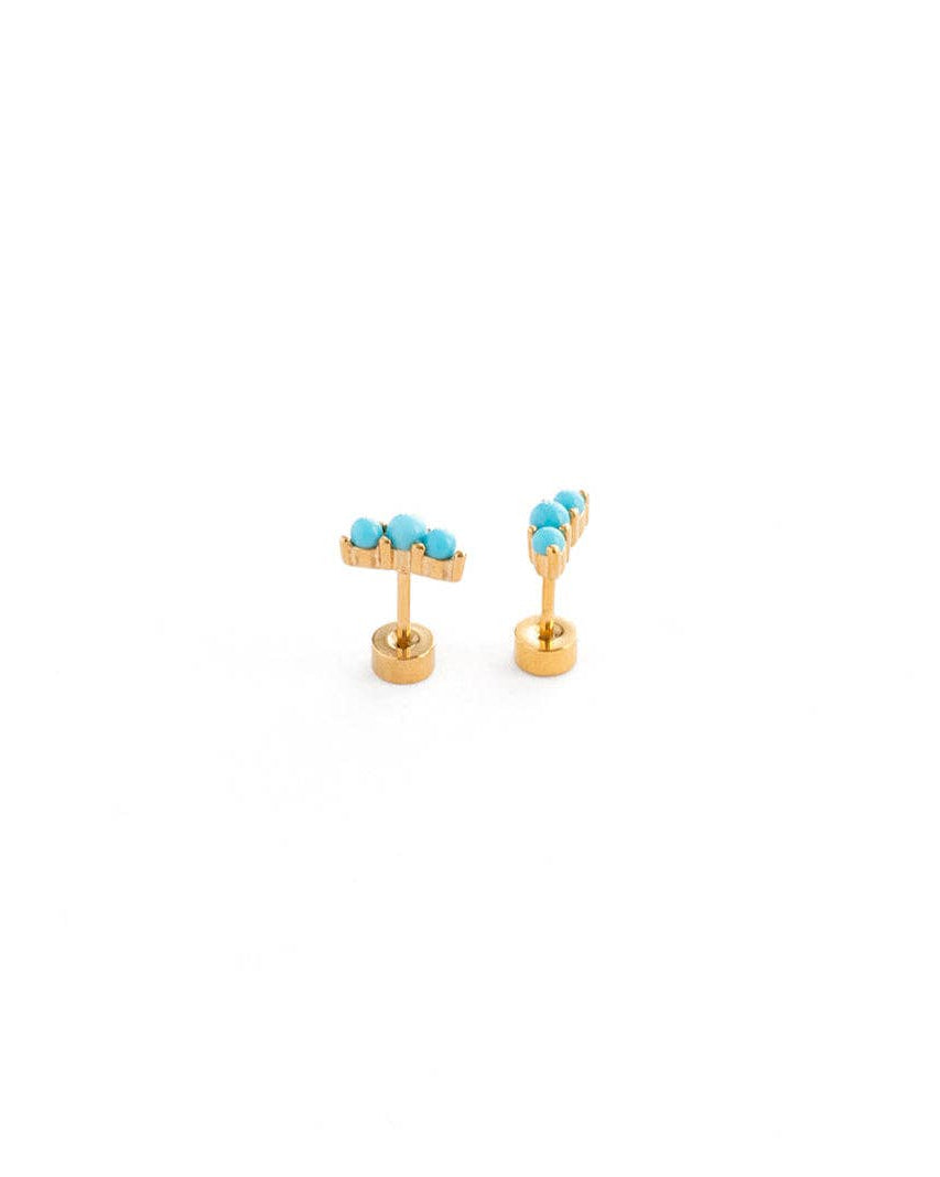 Gold earrings with turquoise stones on a white background