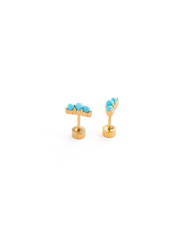 Gold earrings with turquoise stones on a white background