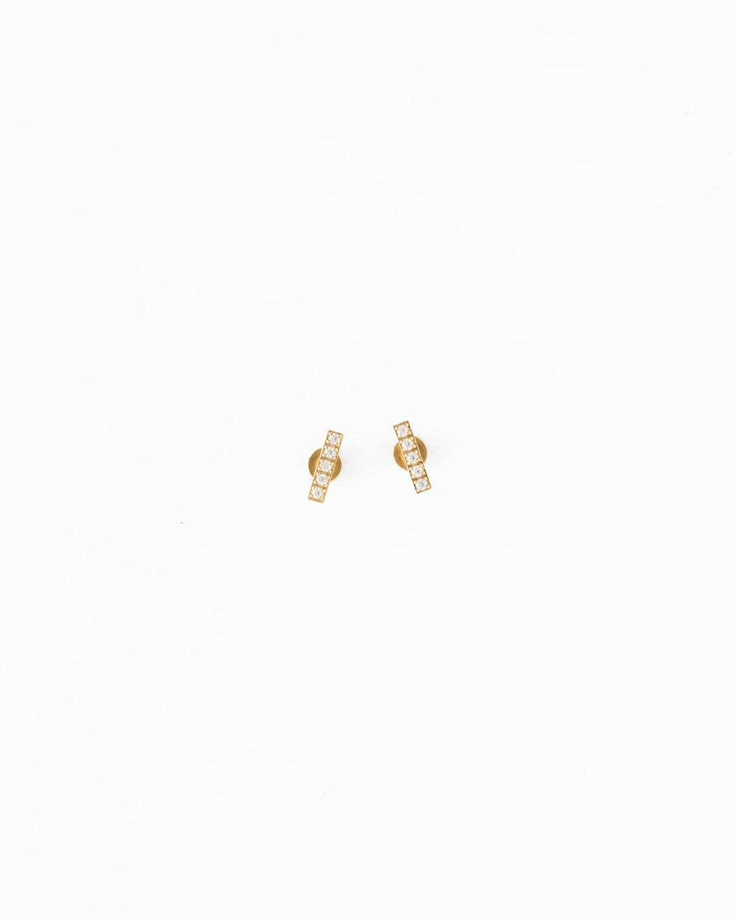 Gold earrings on a white background