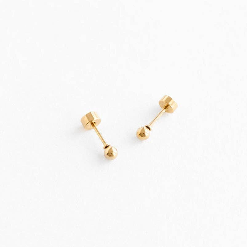 Pair of gold stud earrings on a white background
