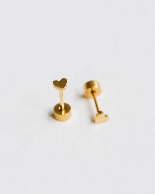 Pair of gold heart-shaped earrings on a light gray background