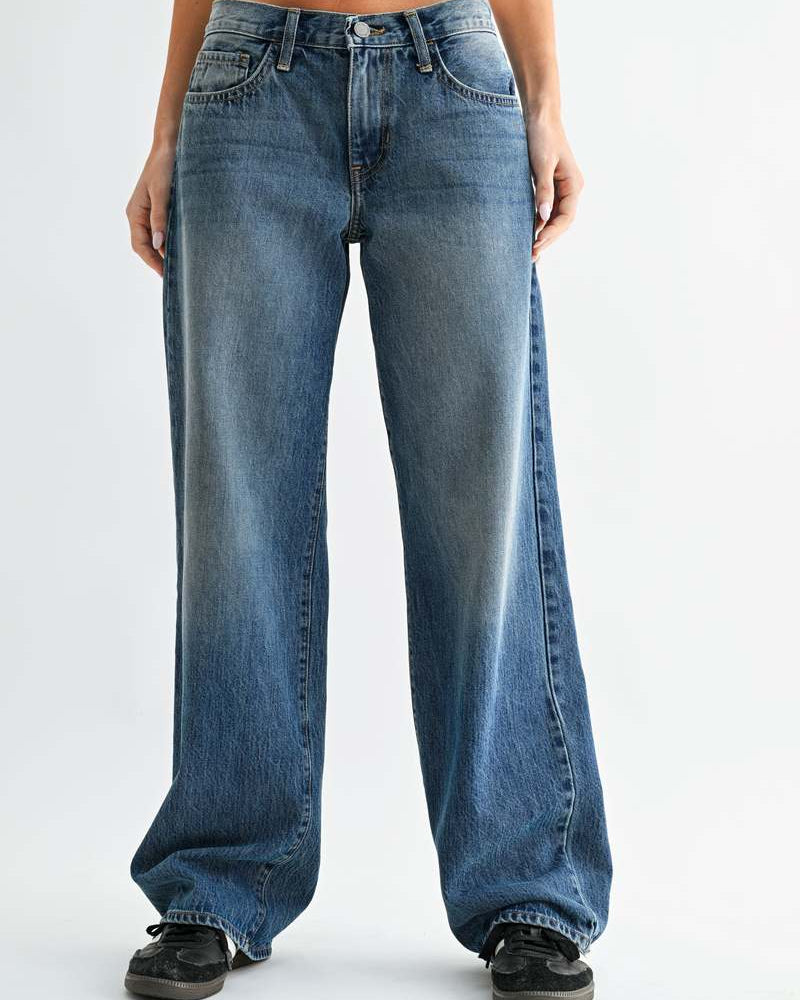 Person wearing blue jeans on a white background
