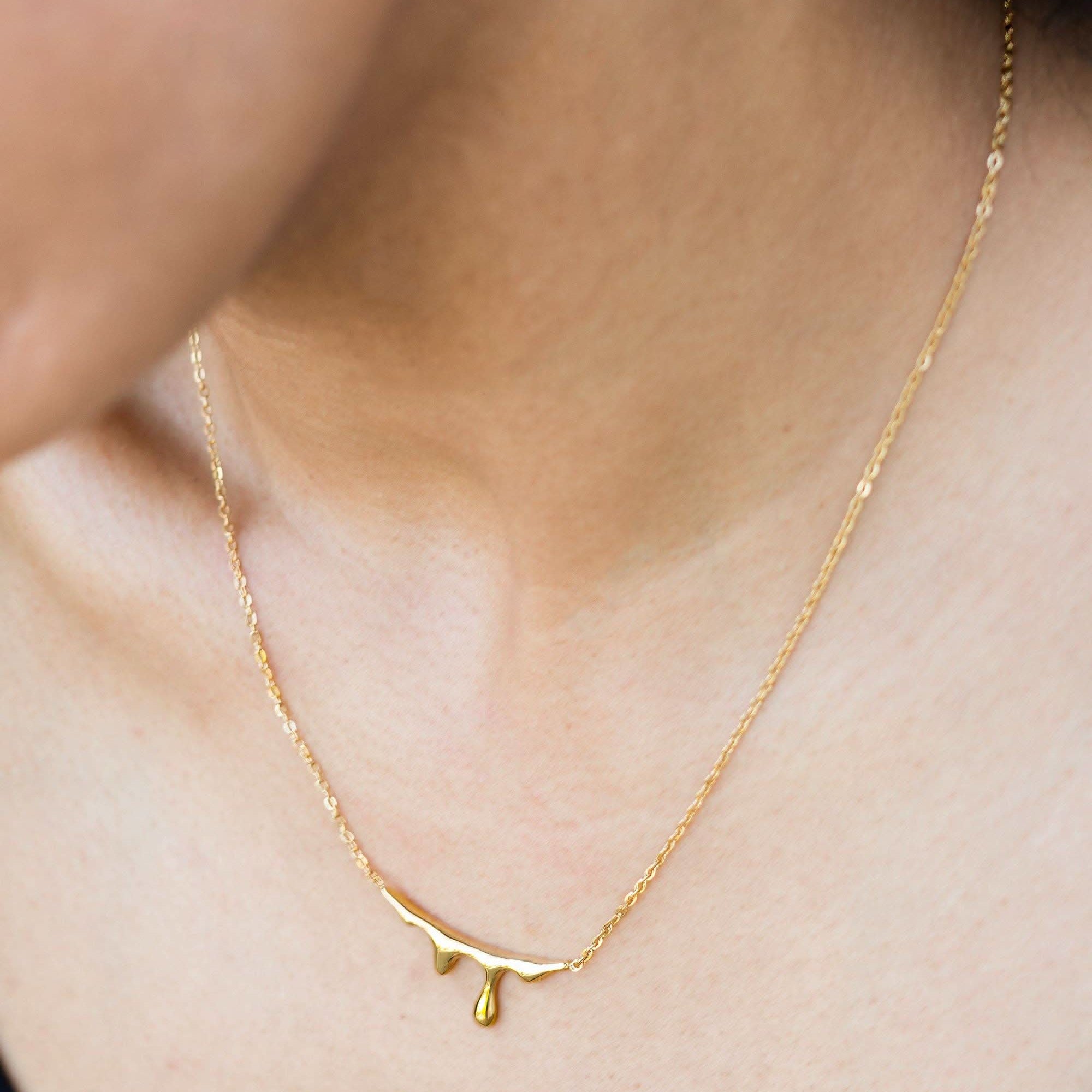 Lava Necklace 18K Gold Plated Gold necklace on a person's neck