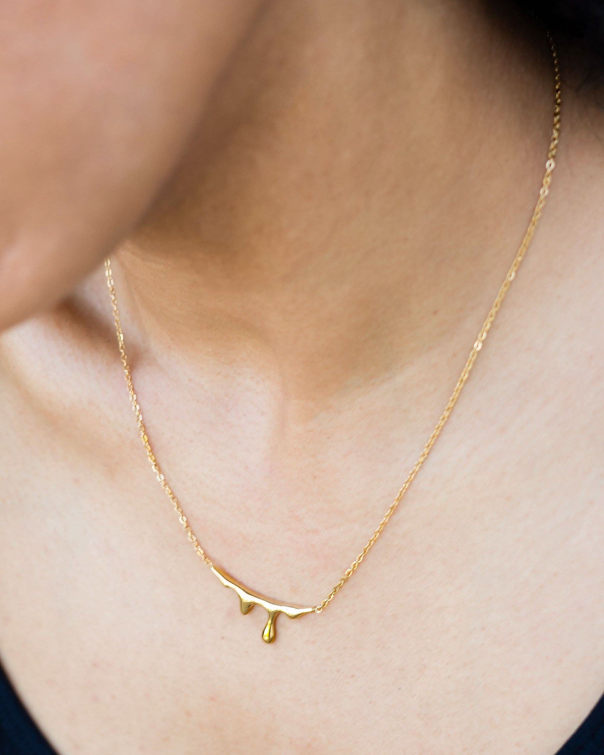 Lava Necklace 18K Gold Plated Gold necklace on a person's neck