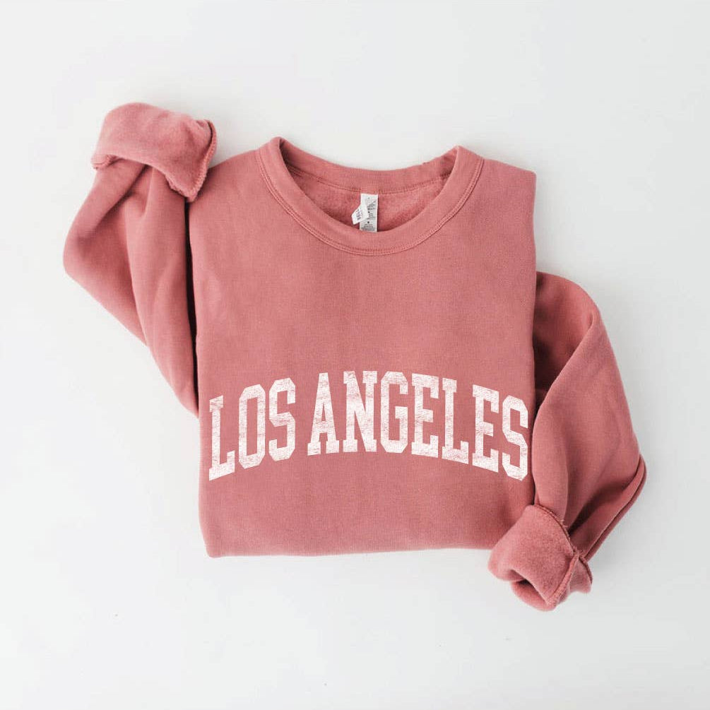 Los Angeles Sweatshirt in a folded, featuring the words "LOS ANGELES" printed in large white capital letters.