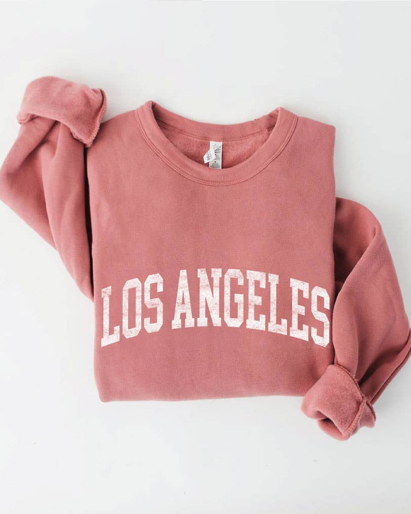 Los Angeles Sweatshirt in a folded, featuring the words "LOS ANGELES" printed in large white capital letters.
