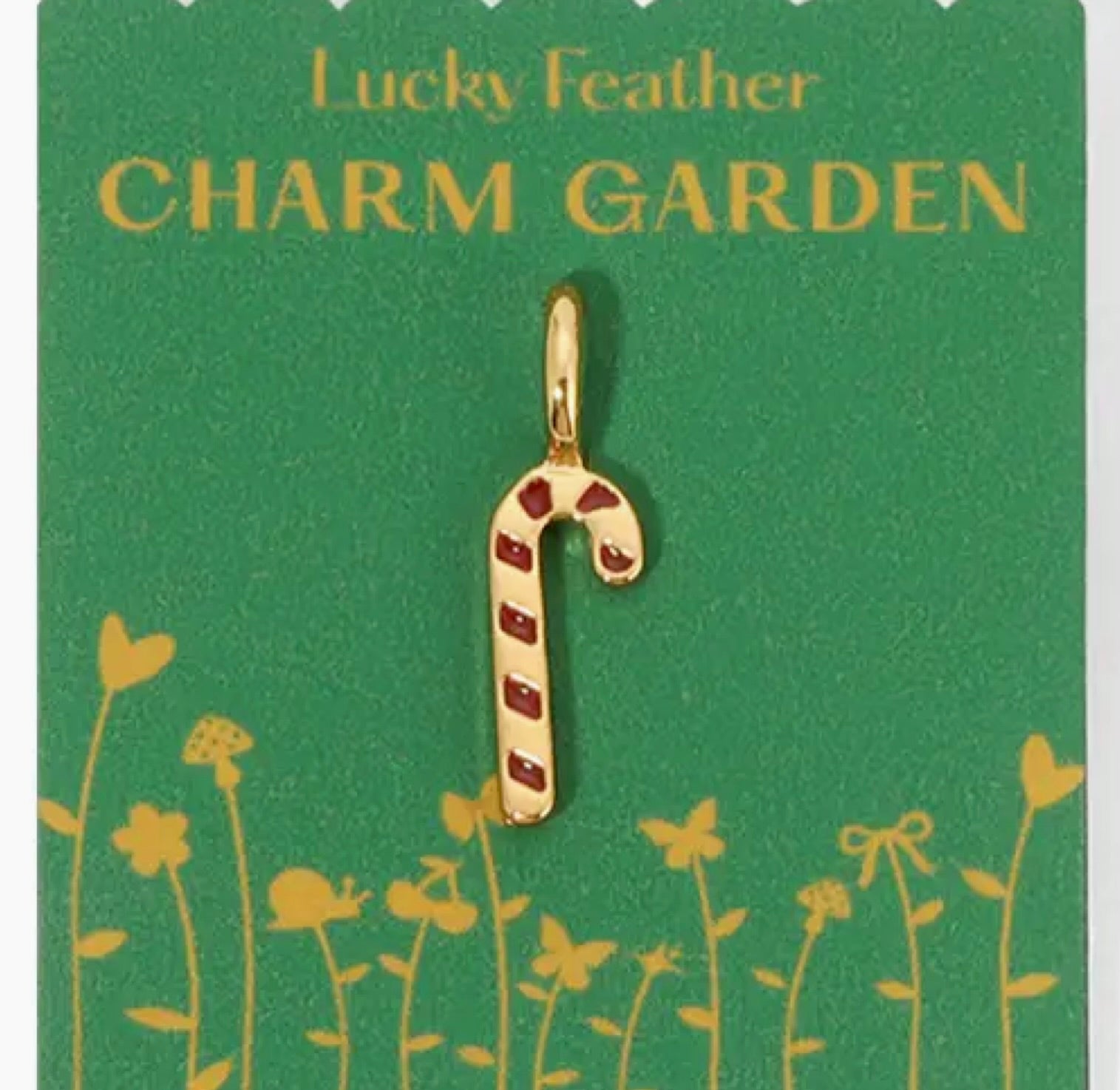 Gold candy cane charm on a green card with 'Lucky Feather Charm Garden' text