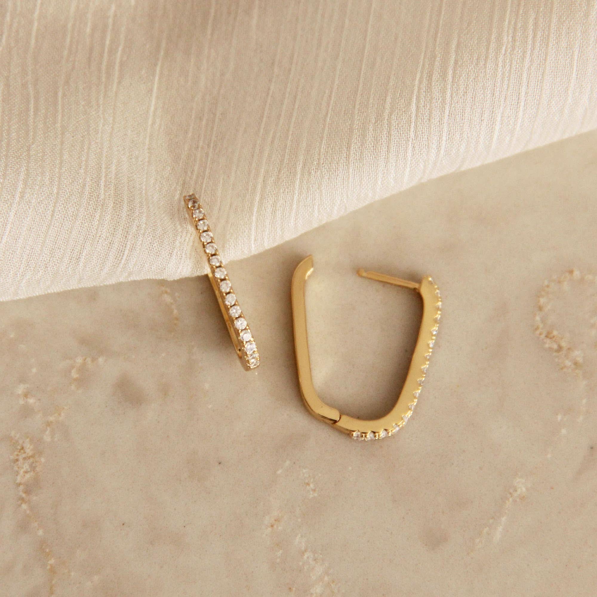 Gold hoop earrings lined with CZ detail shown opened earing