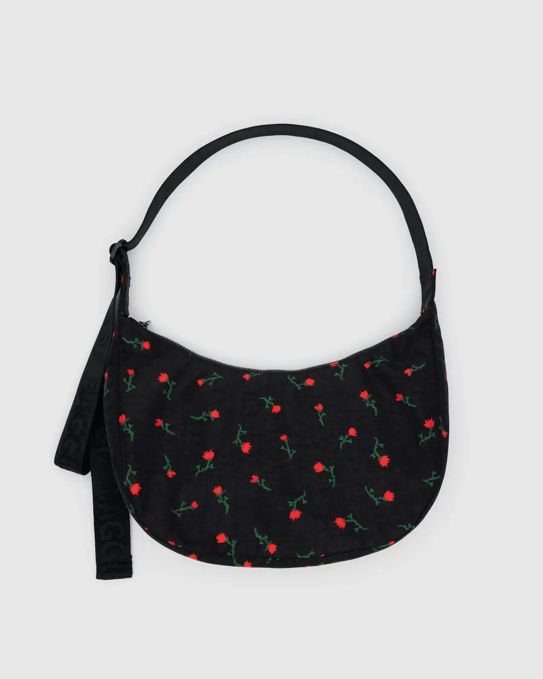 Black handbag with red floral pattern on a light gray background