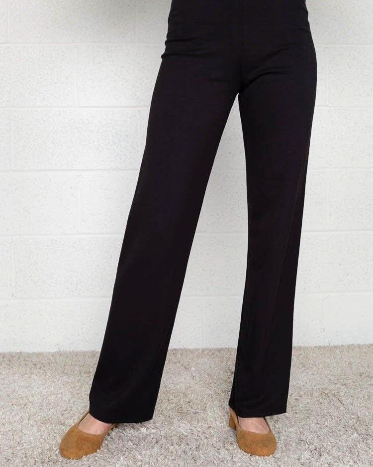 Woman wearing flats and black Micah pants that are skinny on the top with wide bottom