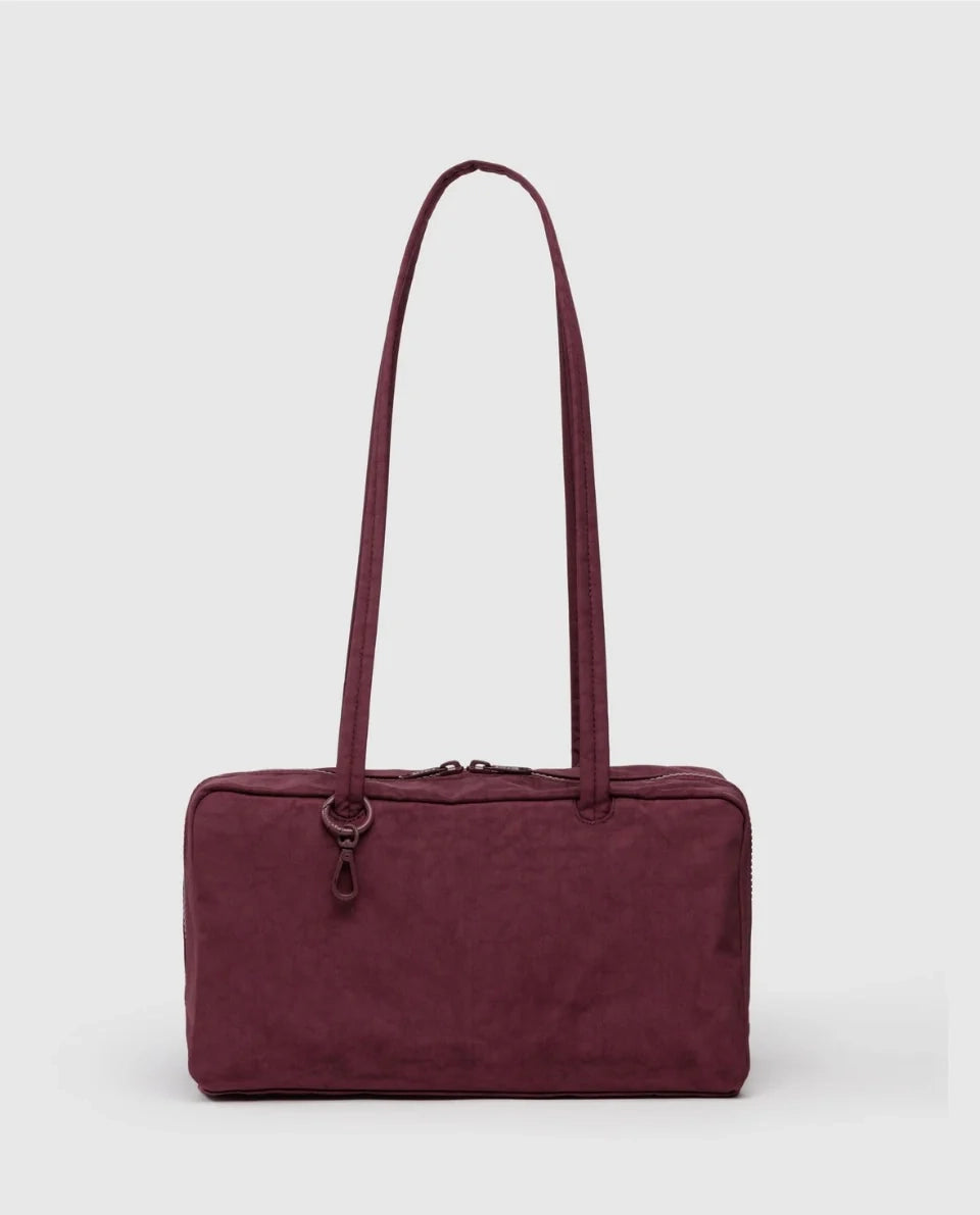 Maroon BAGGU bowler bag with a strap on a white background