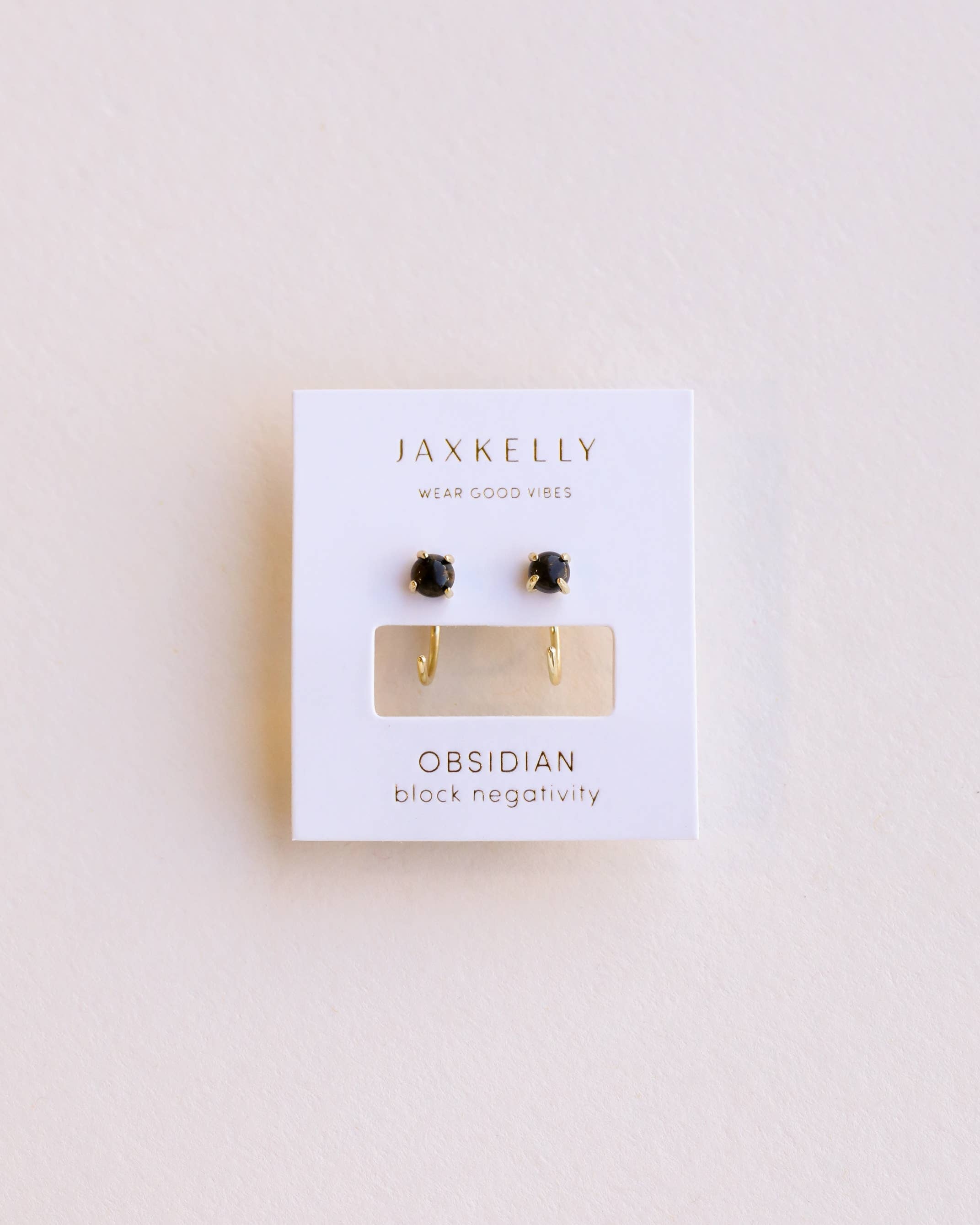 Jaxkelly obsidian earrings on a white card with a light beige background