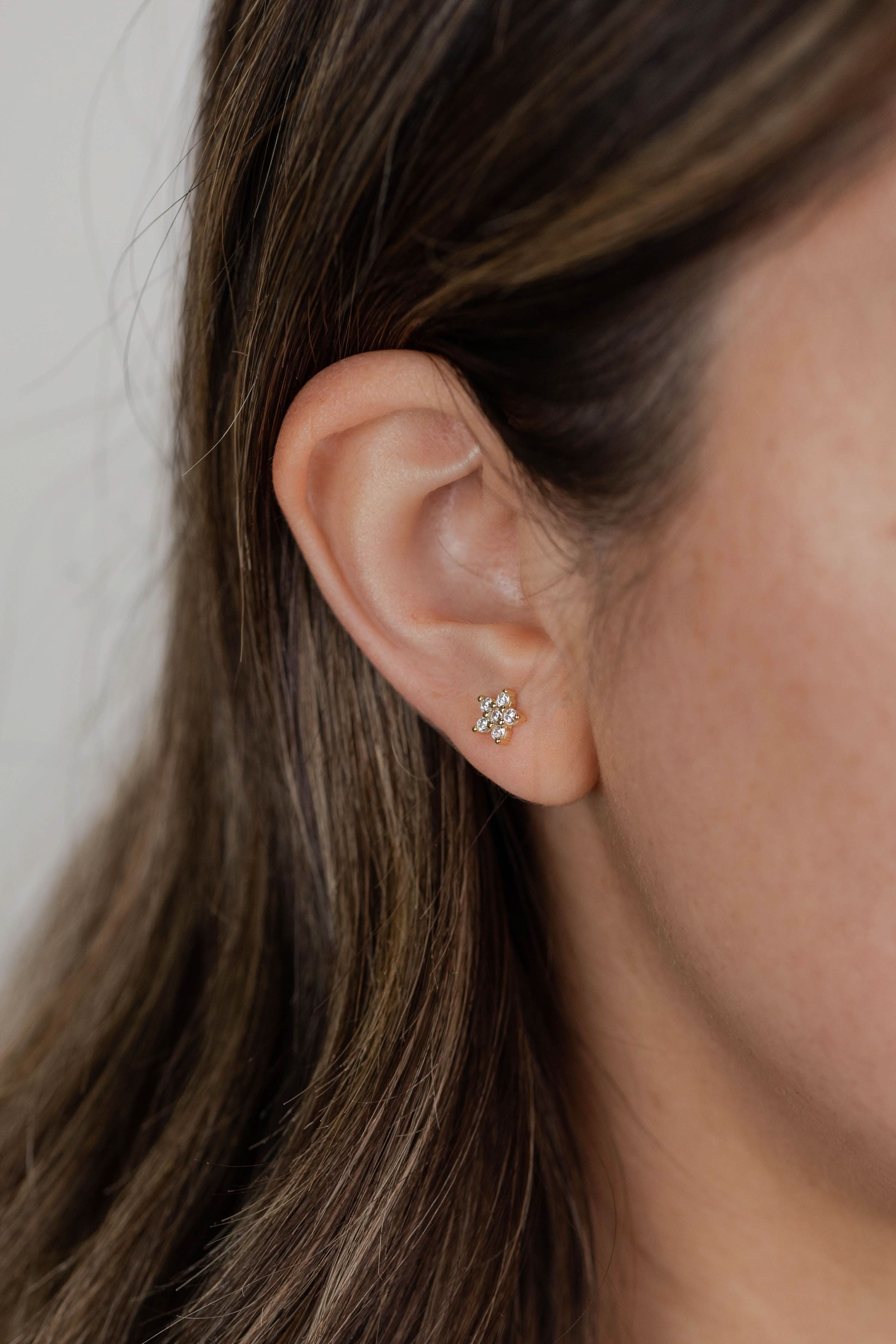 woman wearing pave star stud earrings