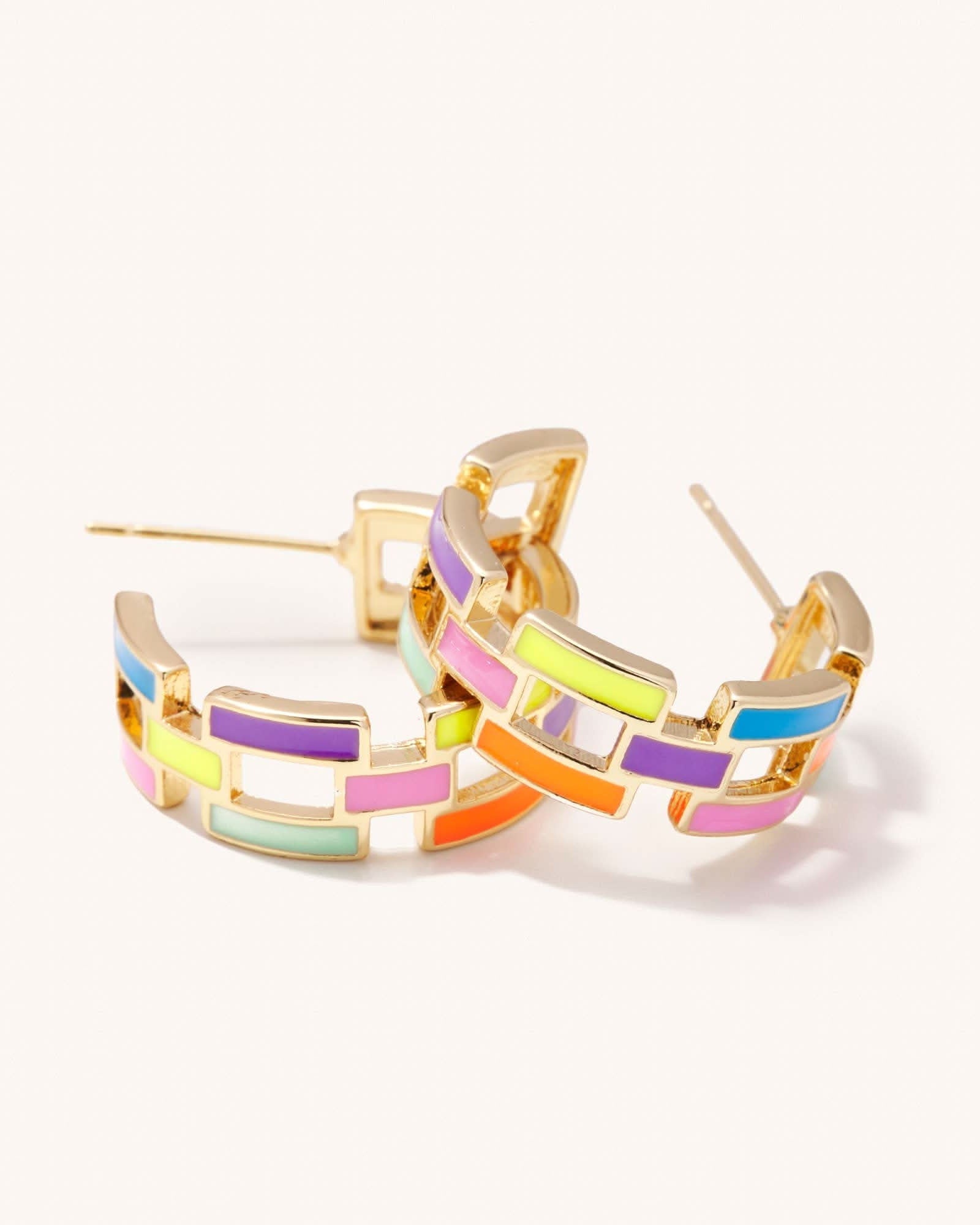 Colorful hoop earrings with gold accents on a white background