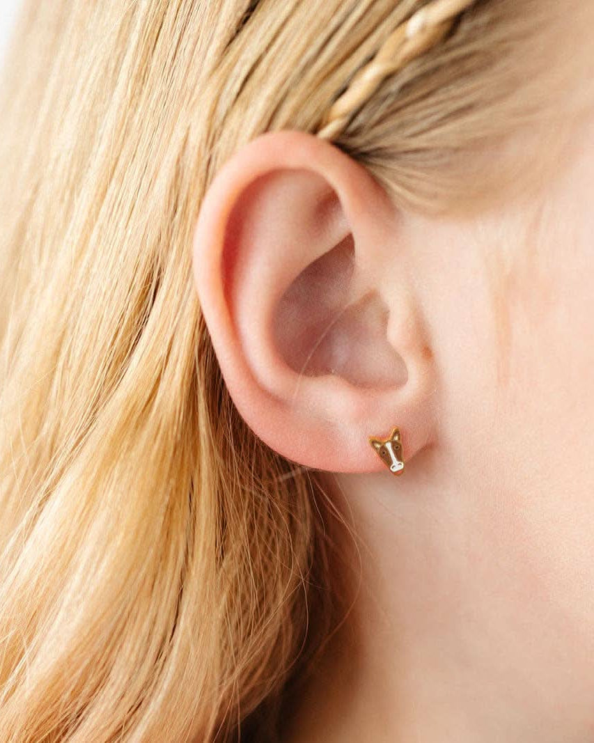 Child wearing A pair of Brown and white horse flat-back gold earrings