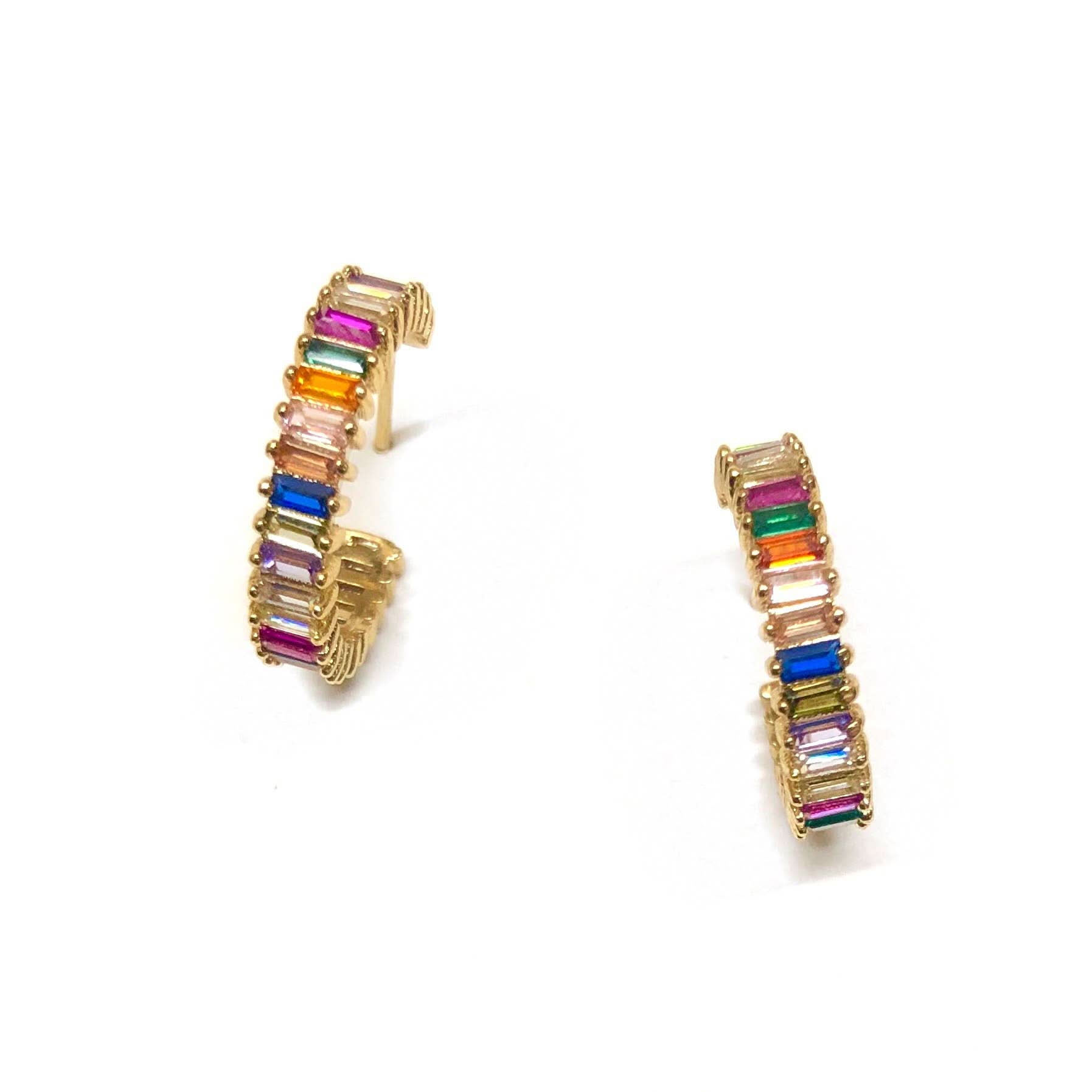 Rainbow colored shimmer hoop earrings laying on a white background