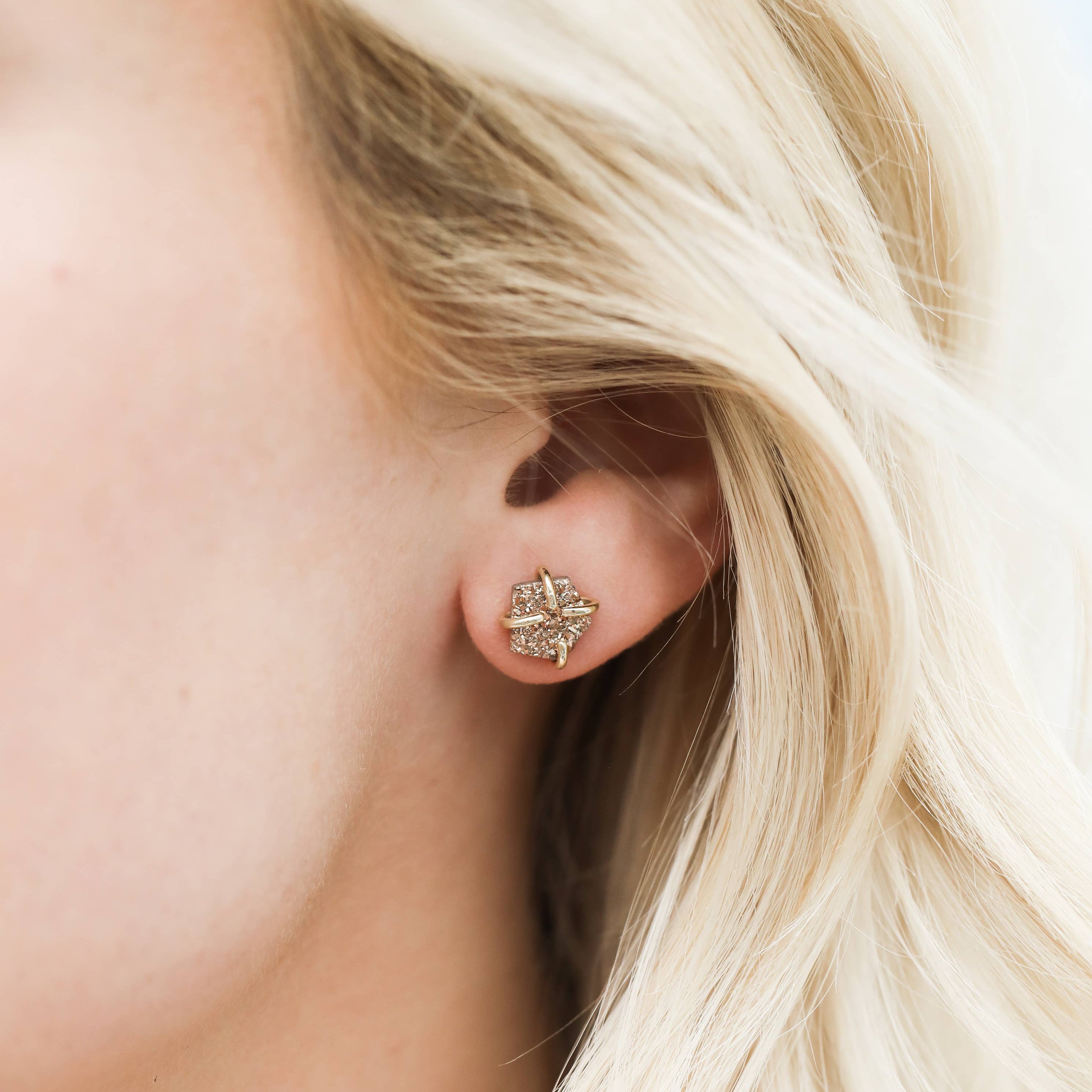 Close-up of a person wearing a diamond Rose Gold Druzy Prong Gold Earrings