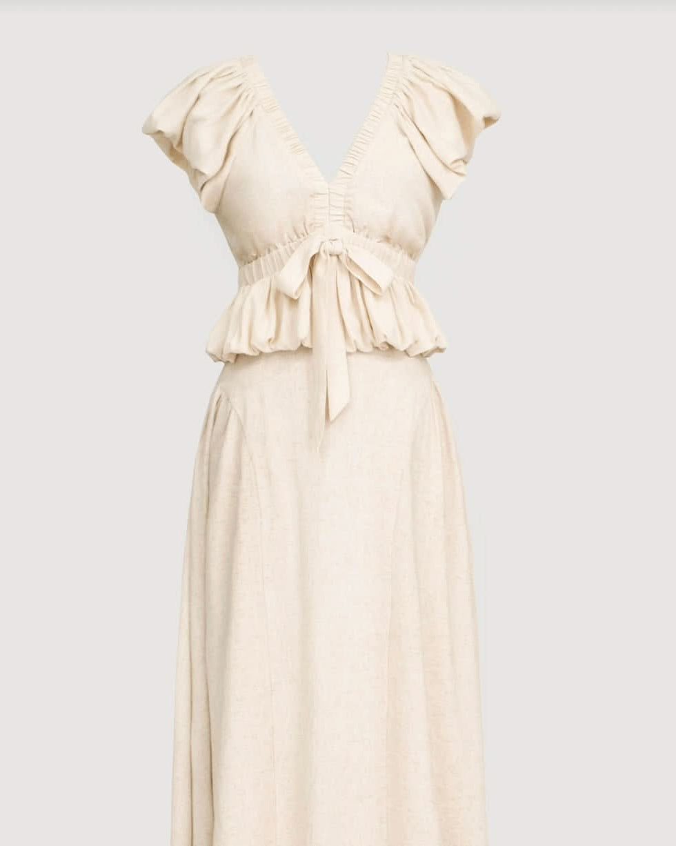 cream beige blouse with delicate ruffle details and voluminous sleeves and matching skirt