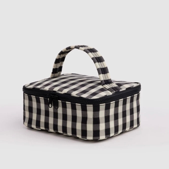 A small rectangular zippered bag with a black and off-white gingham check pattern, featuring a top handle and a black zipper, shown on a light gray background.