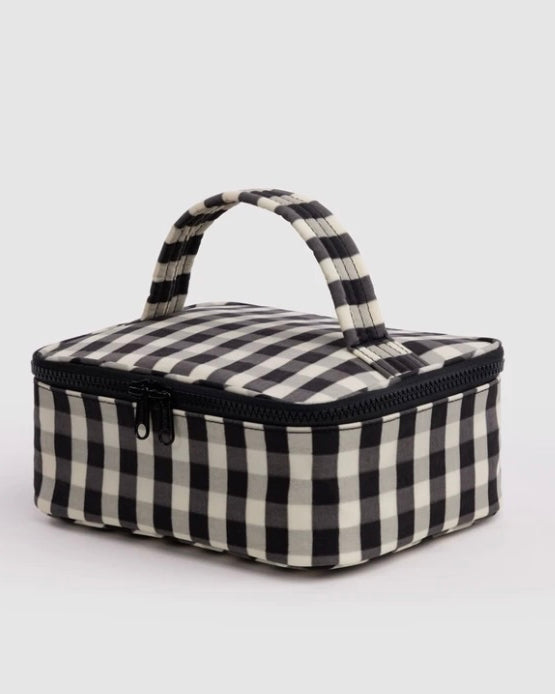 A small rectangular zippered bag with a black and off-white gingham check pattern, featuring a top handle and a black zipper, shown on a light gray background.
