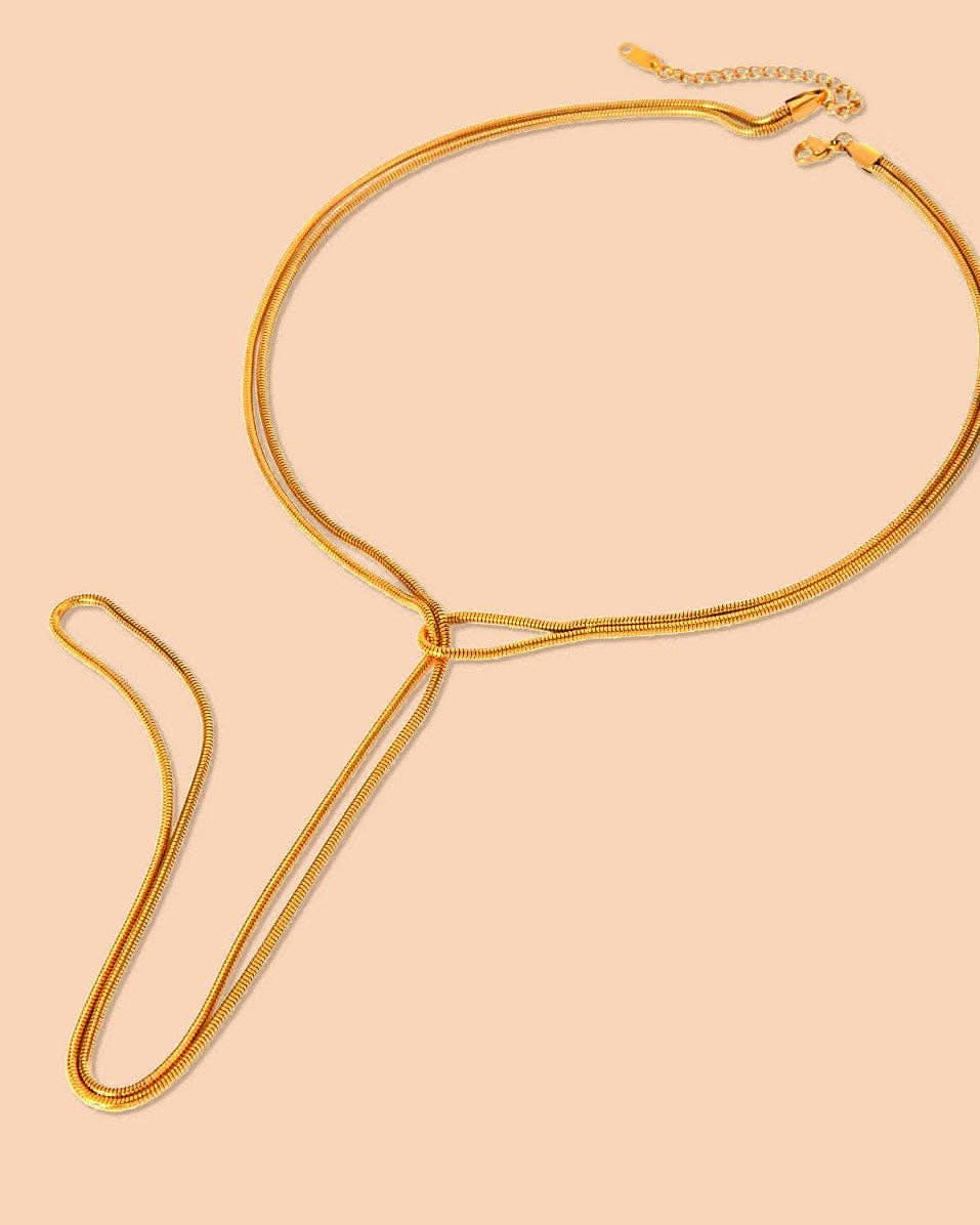 SlipKnot Gold necklace on a beige background