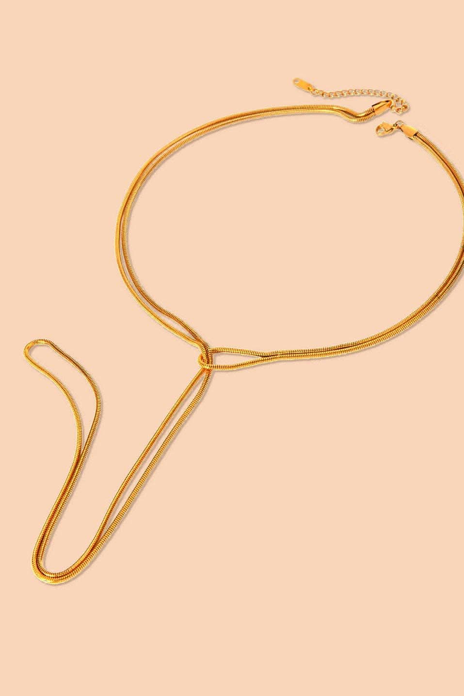 SlipKnot Gold necklace on a beige background