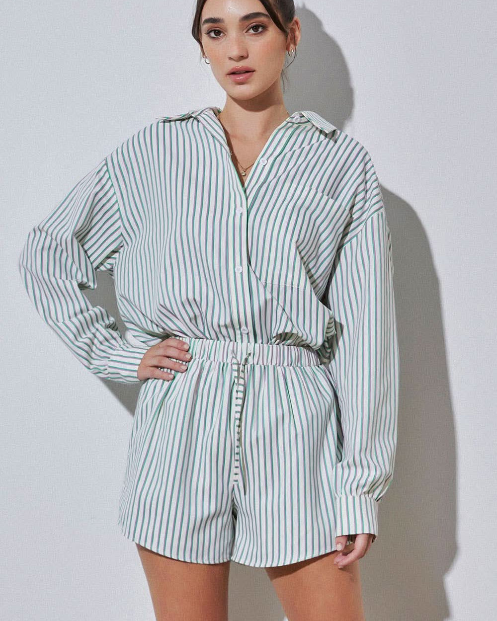 Woman wearing vertically striped green purple and blue set