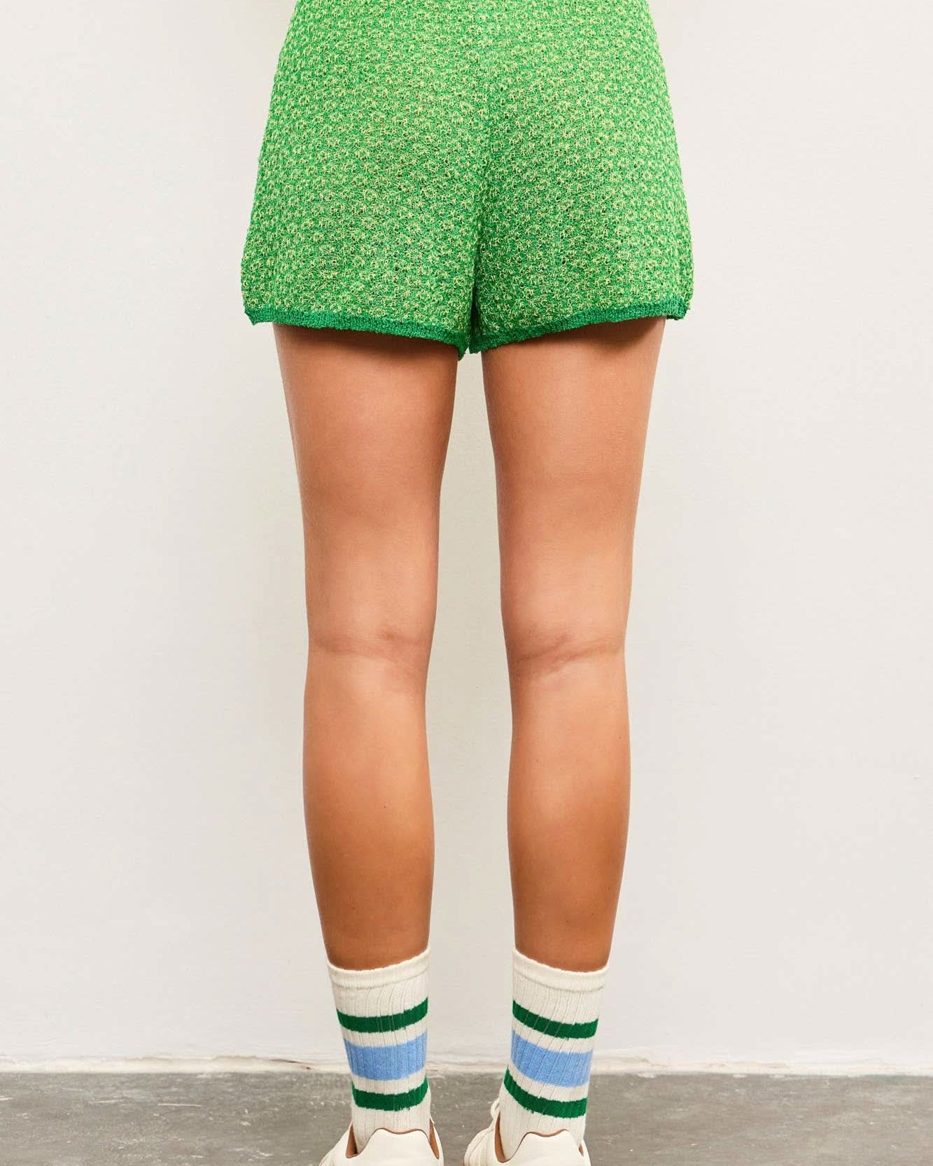 Green patterned shorts worn comfortable tie waist allows for a customizable fit.