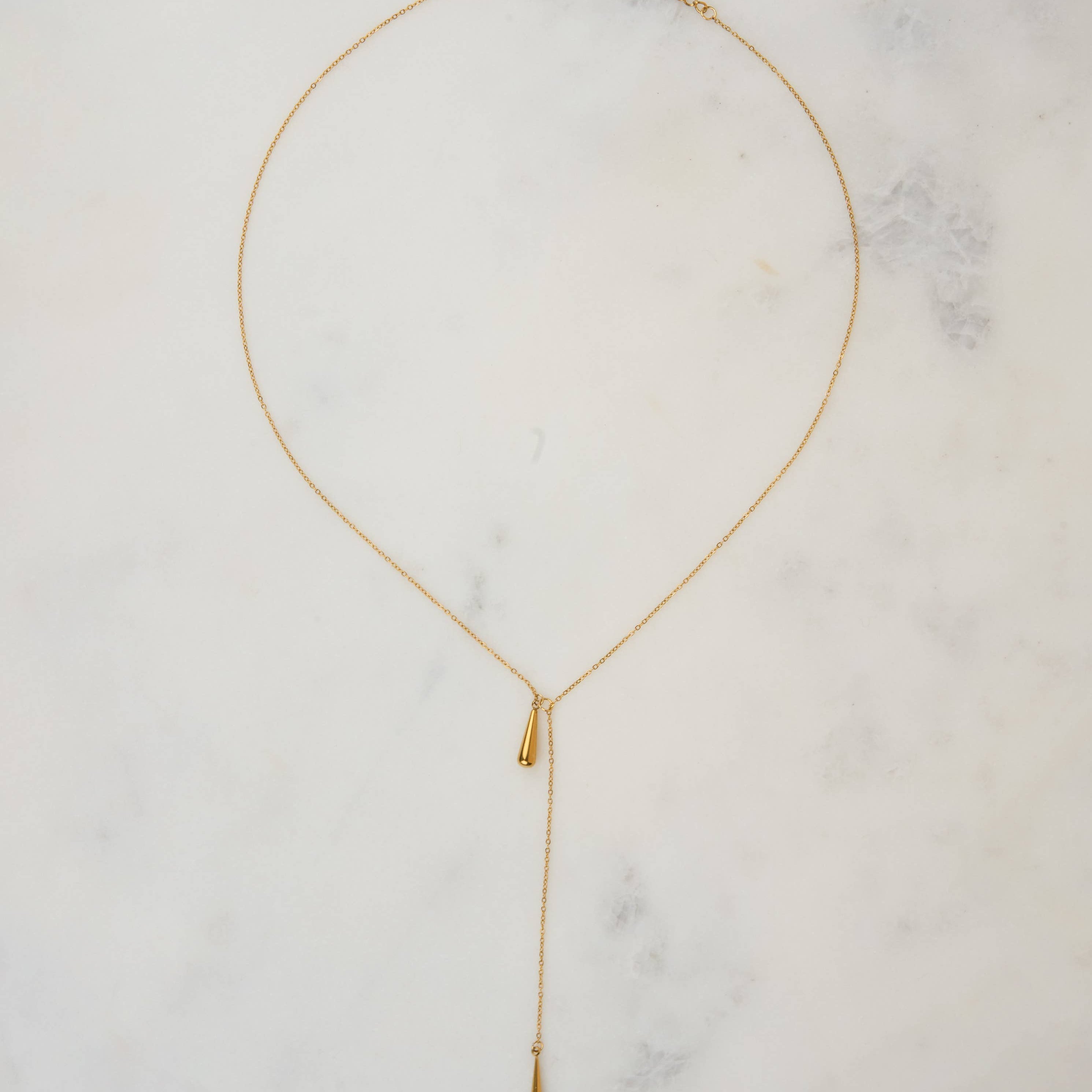 Tear Drop Threader Necklace Gold necklace on a marble surface
