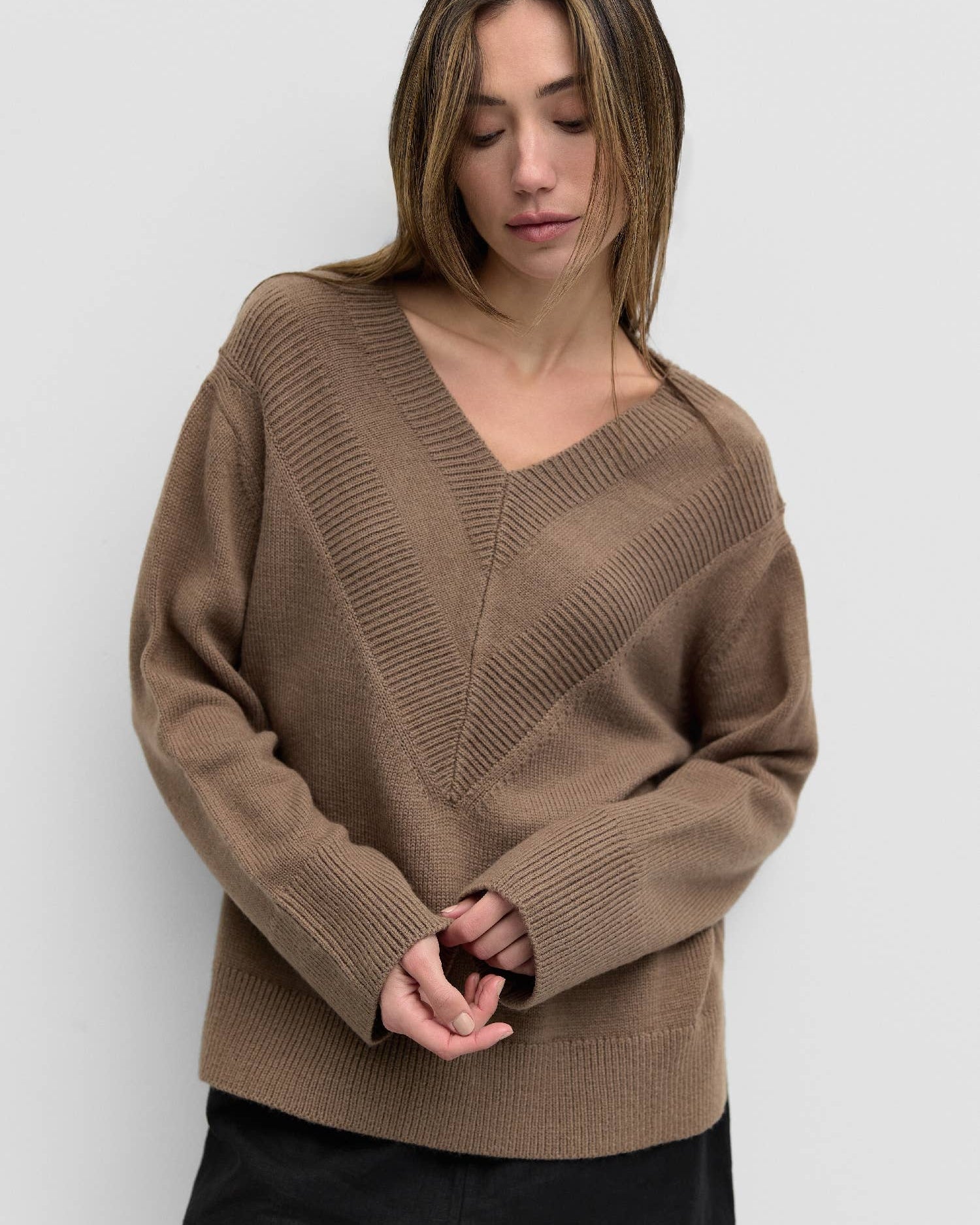 Nevada Sweater is an oversized sweater featuring a ribbed v-neck for texture
