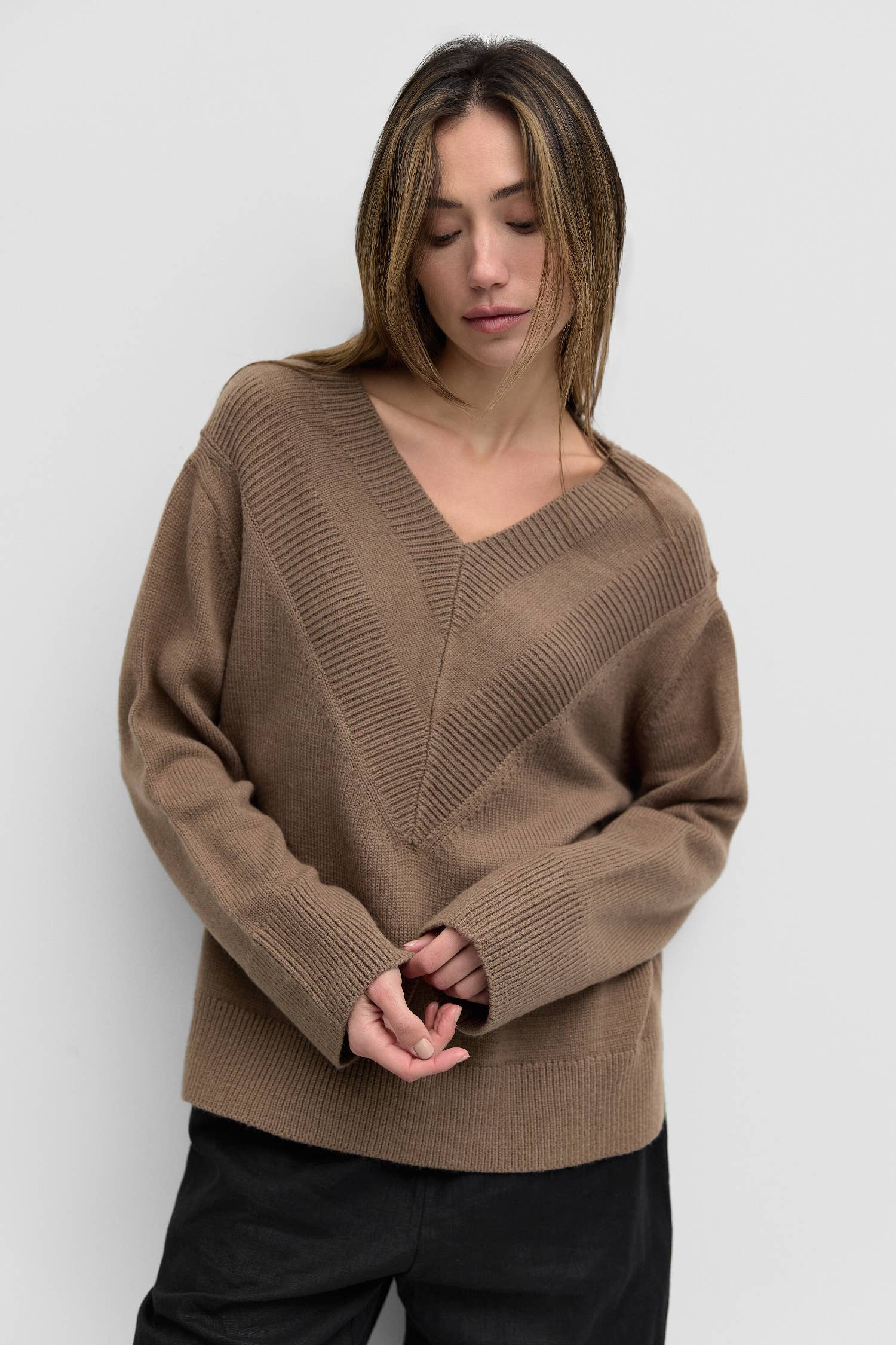 Nevada Sweater is an oversized sweater featuring a ribbed v-neck for texture