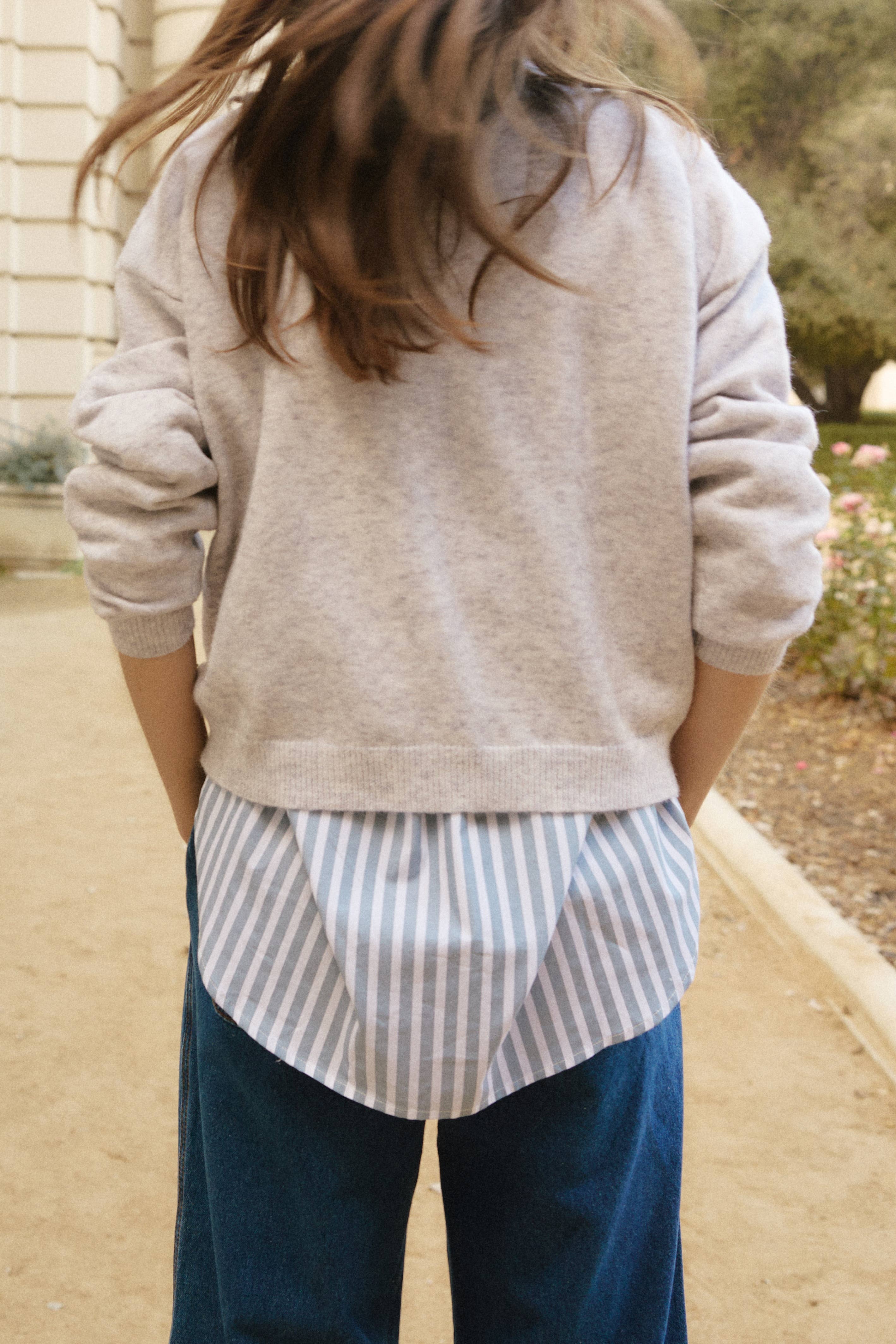 This comfortable, multi-colored knit sweater is designed with a relaxed fit