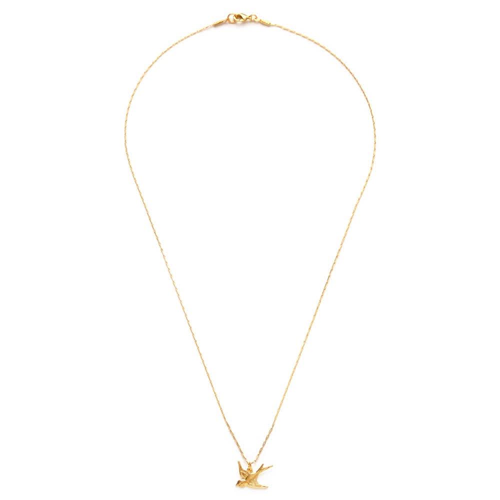 Gold necklace with a small pendant on a white background