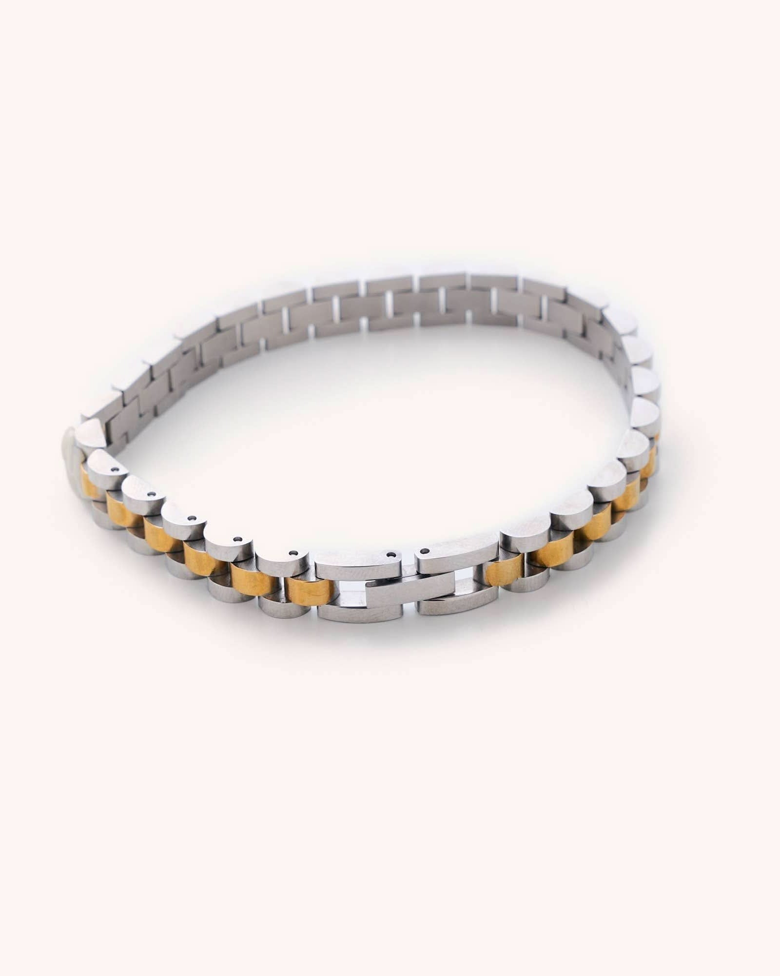 Waterproof silver and gold Cuban Link 6" plus a 2" extender laying on white background