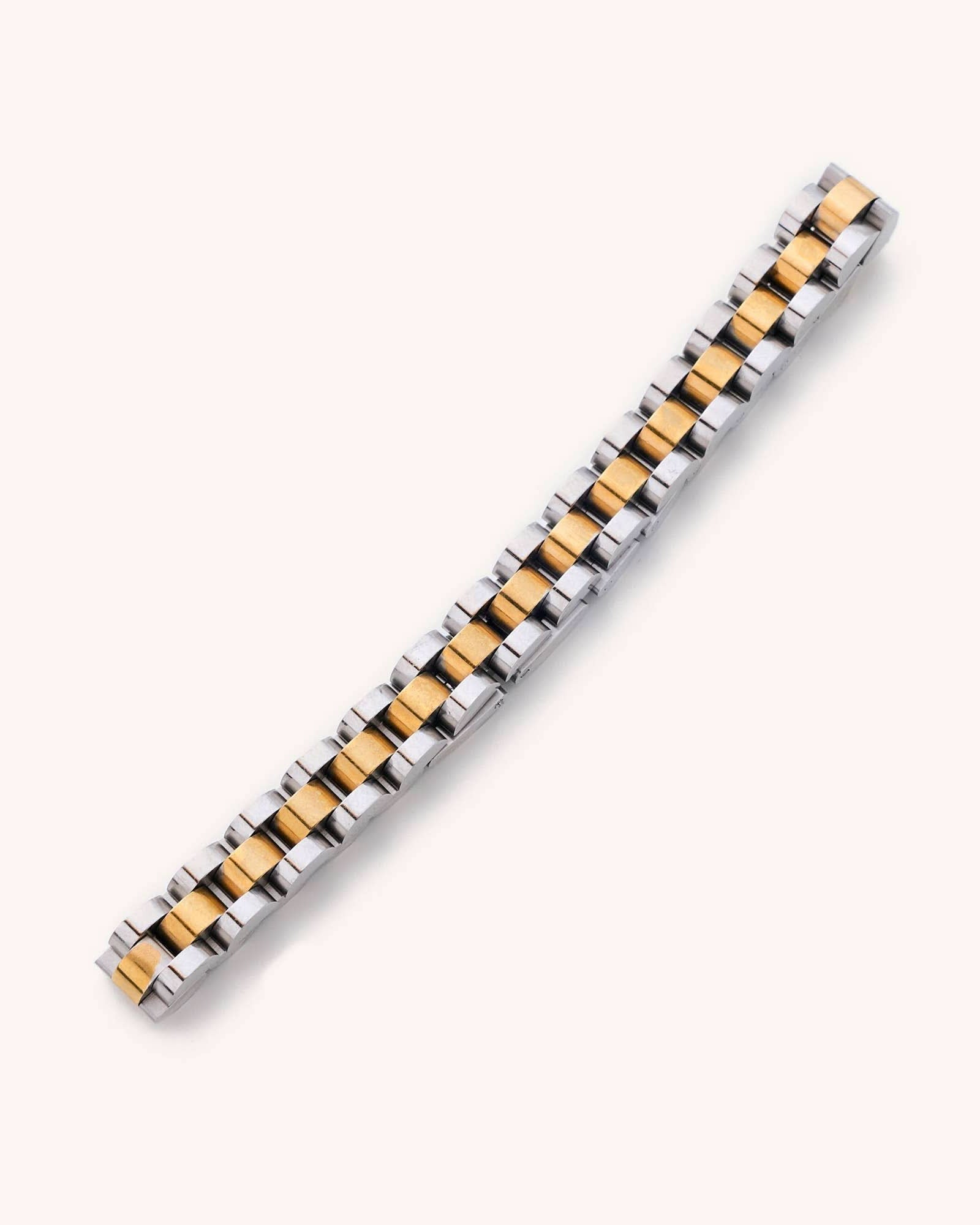 Waterproof silver and gold Cuban Link 6" plus a 2" extender laying on white background