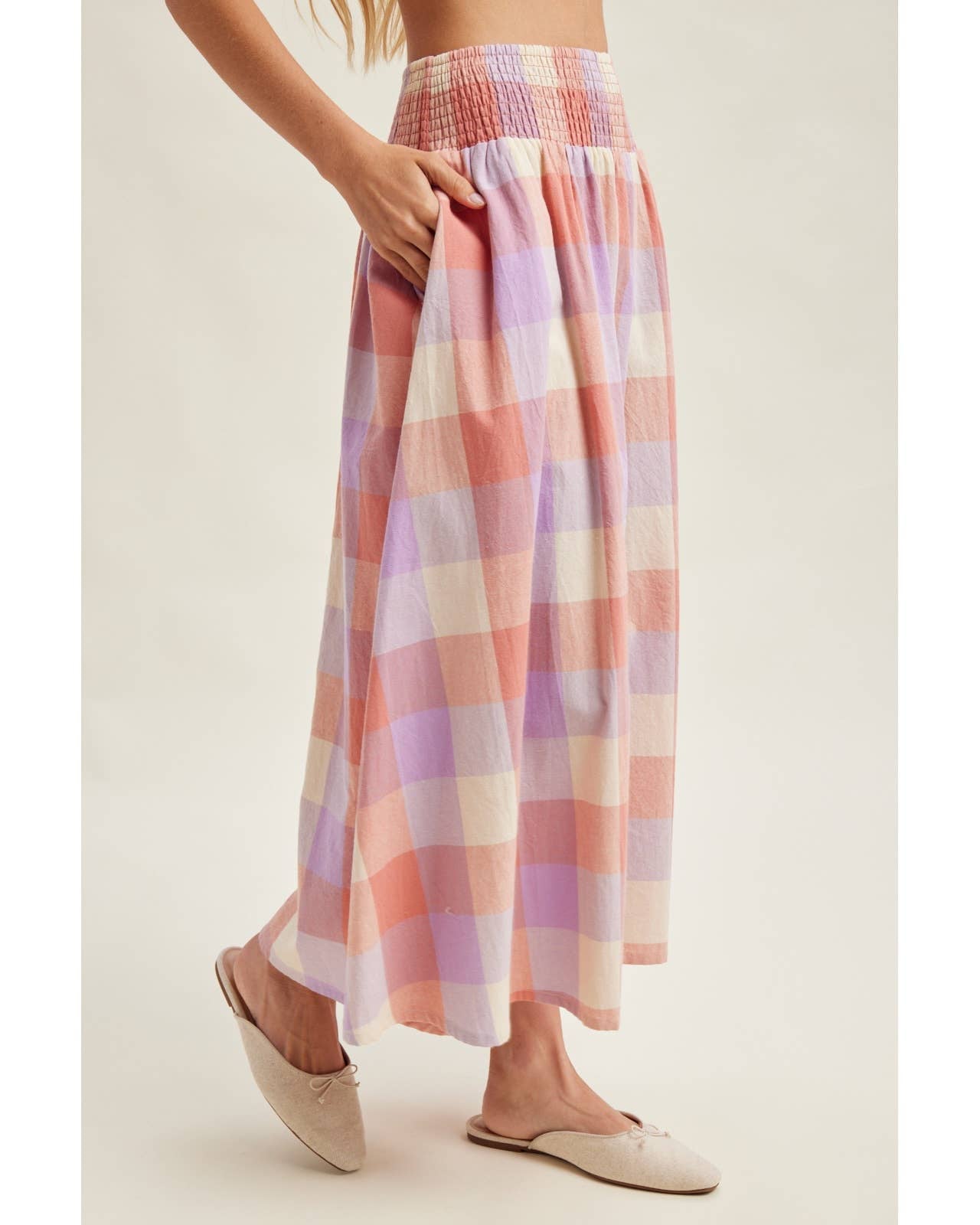 Pastel plaid skirt worn by a person on a plain background