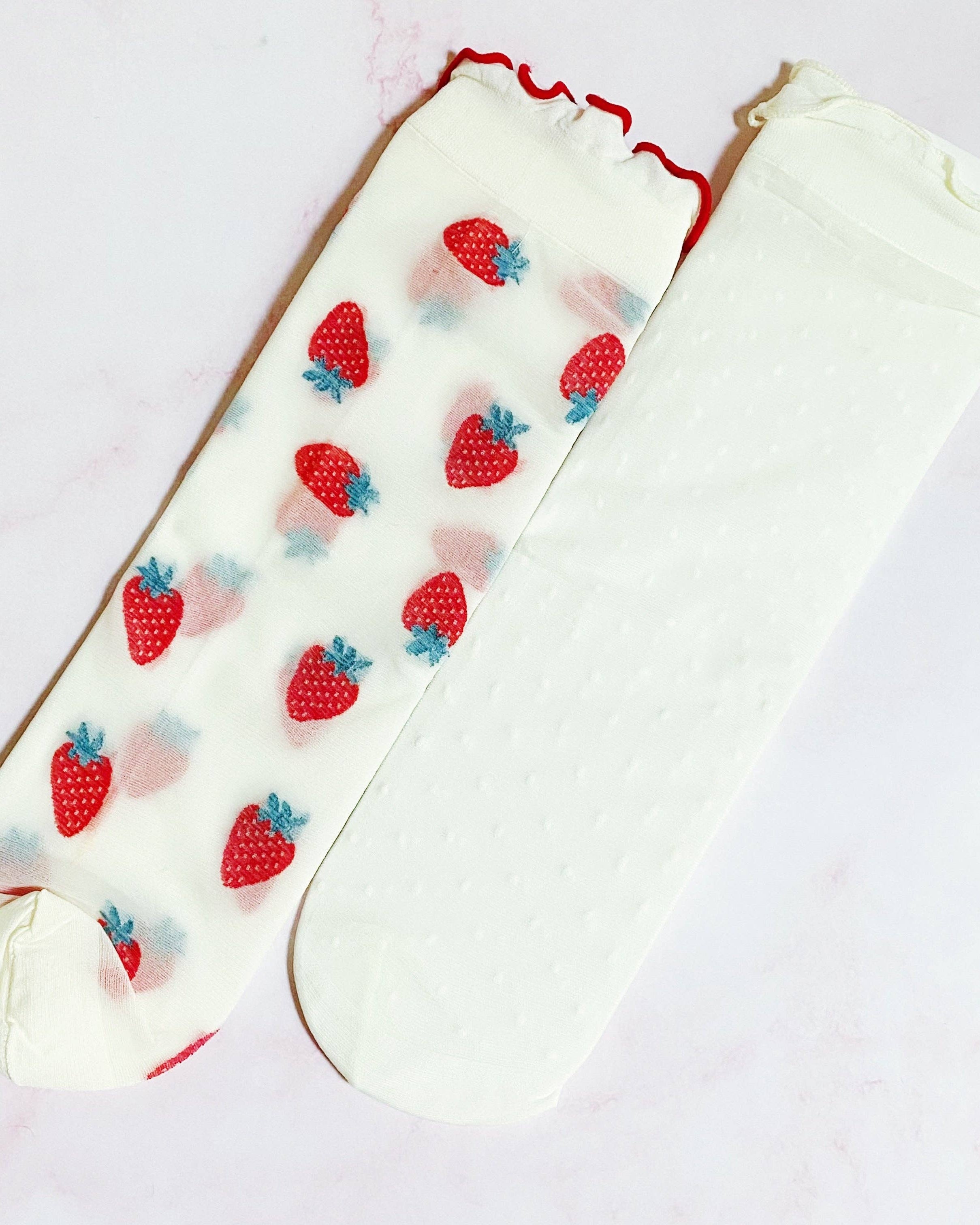White knee-high socks with strawberry pattern on a white background