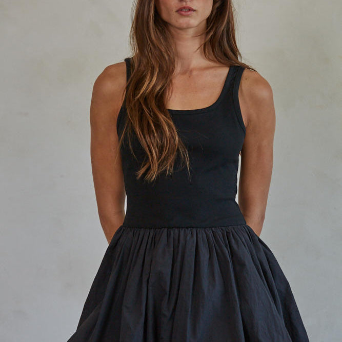 Aster Mini Skort Dress
Woman wearing a black sleeveless dress