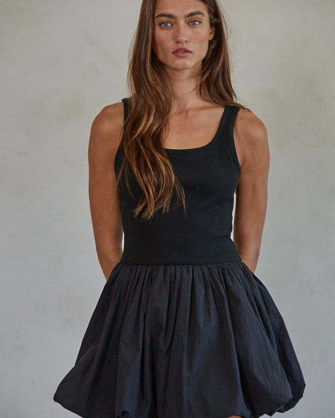 Aster Mini Skort Dress
Woman wearing a black sleeveless dress