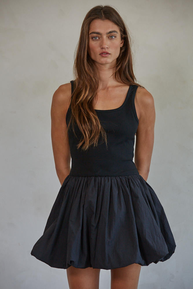 Aster Mini Skort Dress
Woman wearing a black sleeveless dress