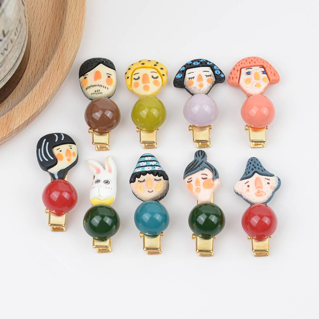 Colorful hair clips with character designs on a white background