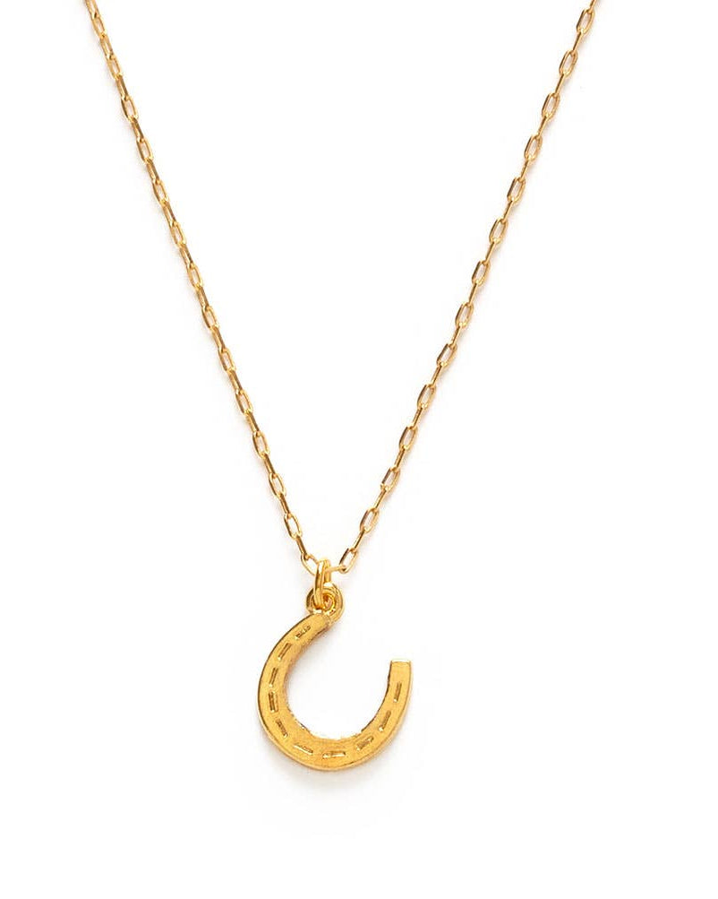 Gold horseshoe necklace on a white background