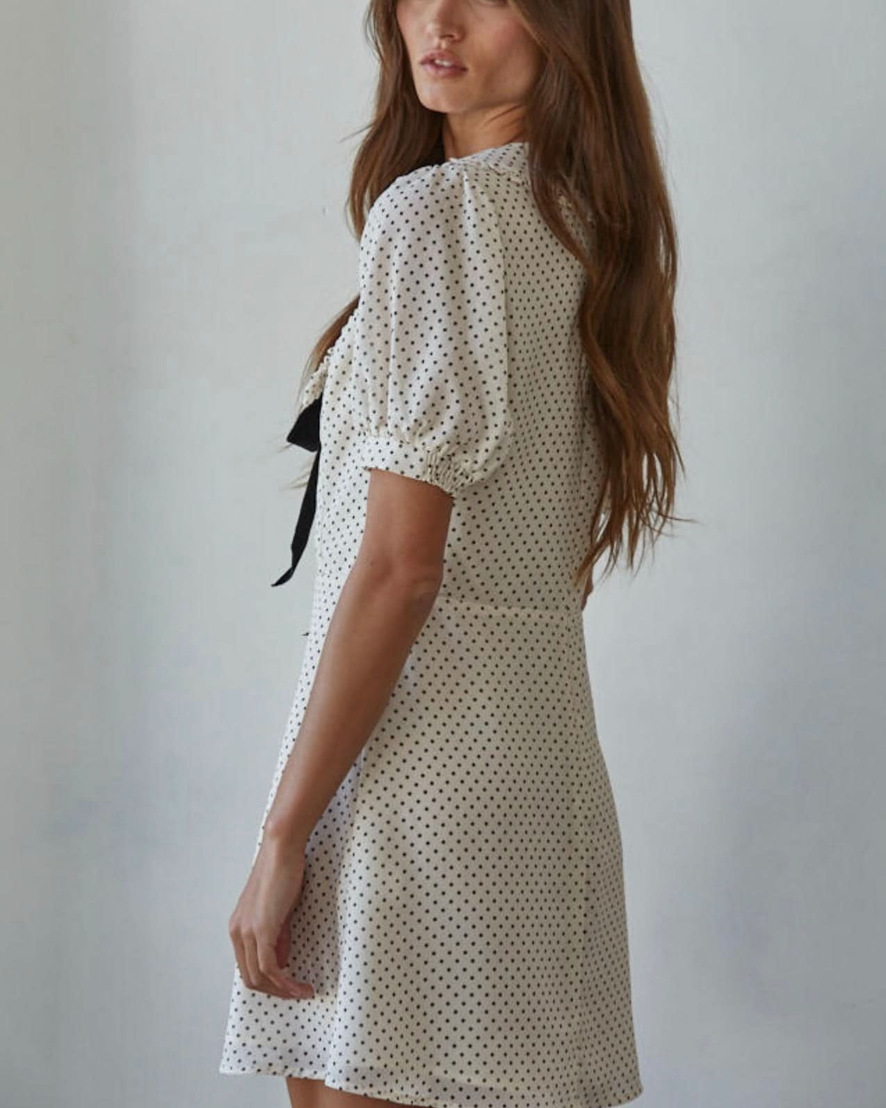 Polka Dot Dress Woman wearing a white dress with black polka dots