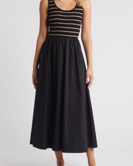 Woman wearing a black dress with a striped top on a white background