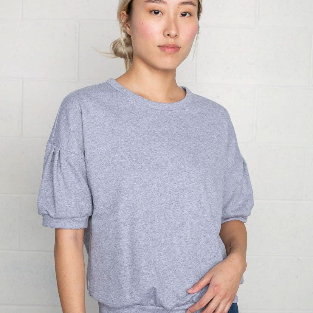 Woman wearing natural grey, short sleeve, puff sleeve, blouse t-shirt top