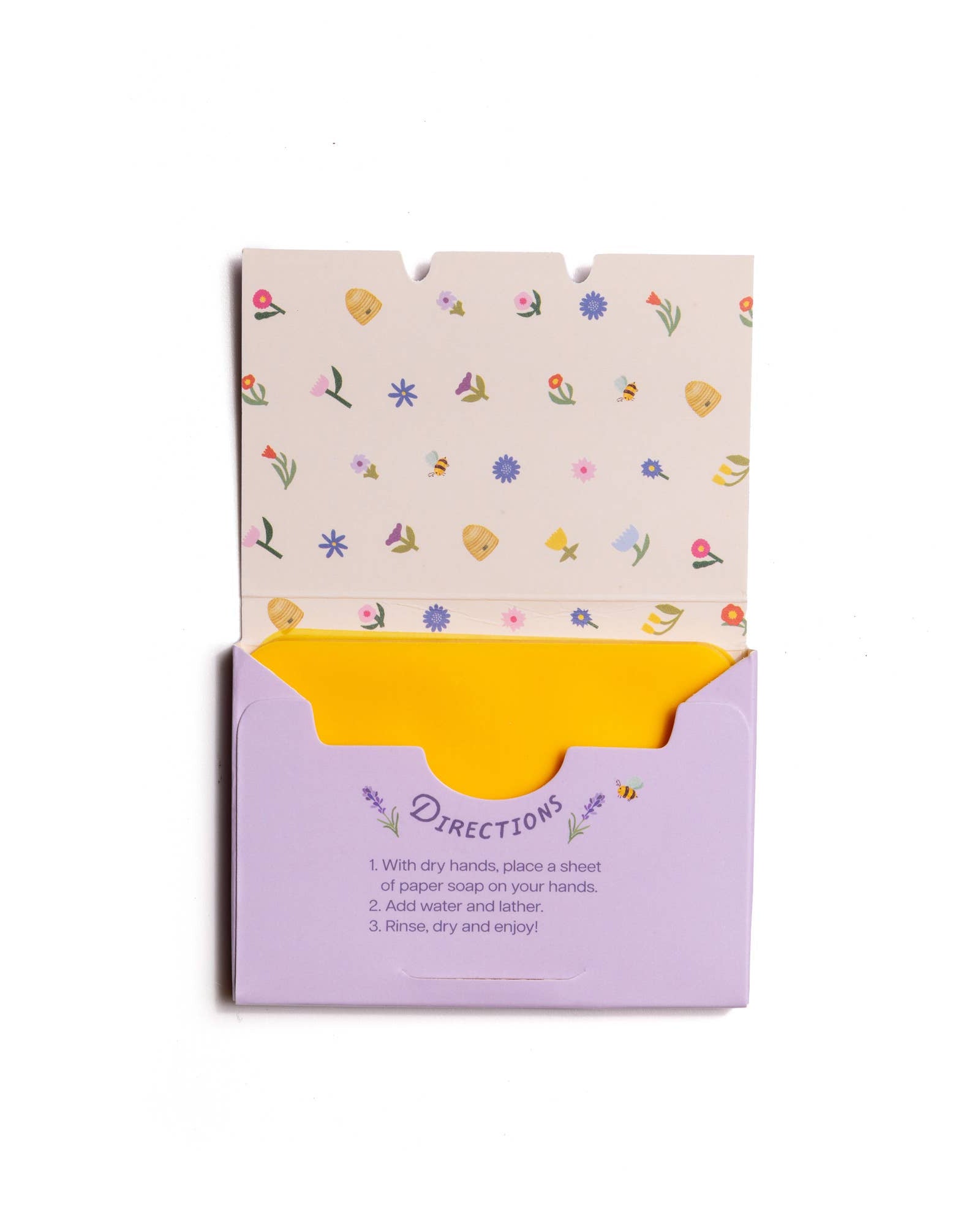 Product packaging with floral design on top and purple base with text on a white background