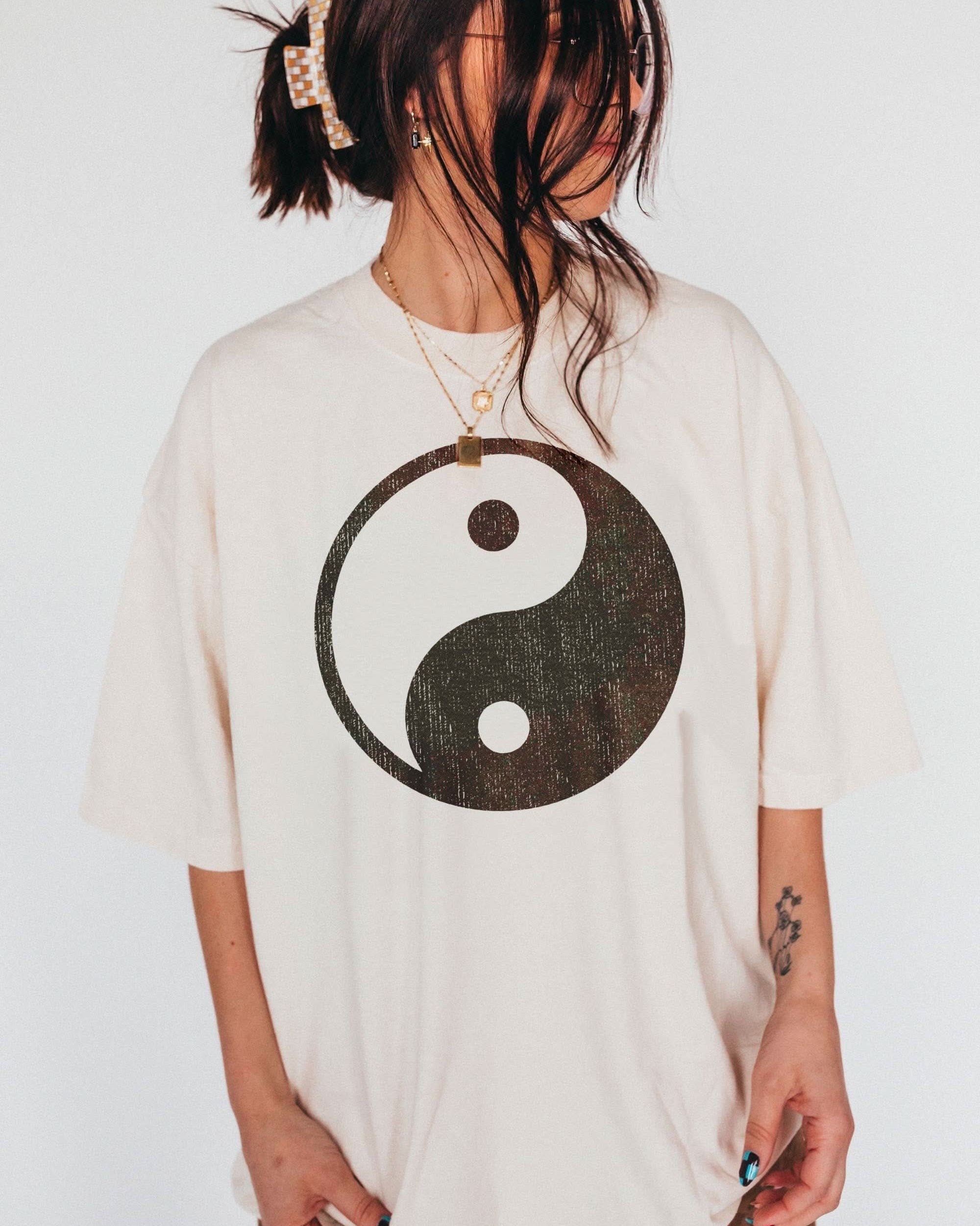 woman wearing hand printed, entirely cotton t-shirt with distressed boho Yin-yang design